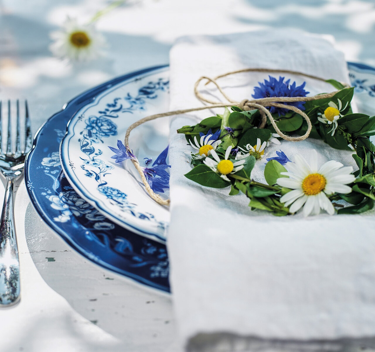 Krans med blommor på tallrikar från servisen Aspvik